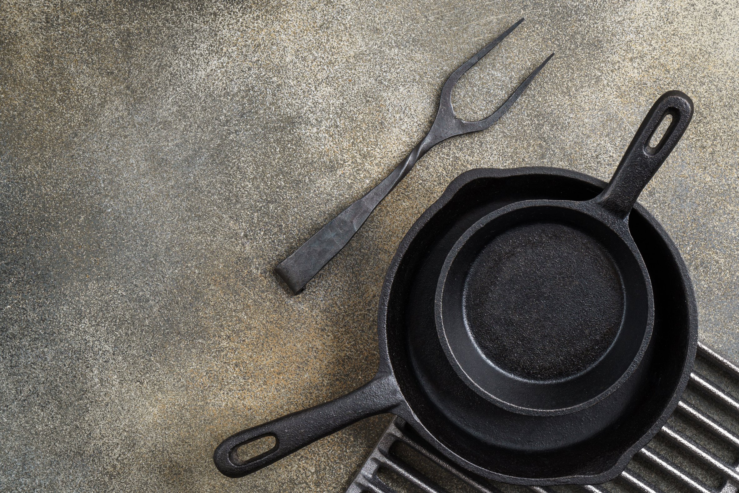 Two cast iron pans and fork